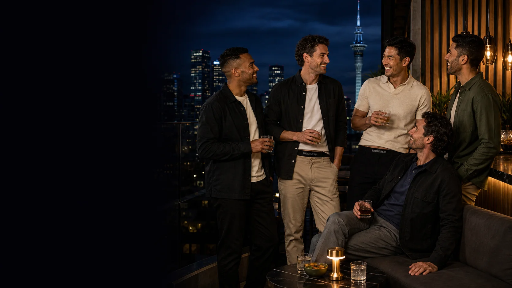 Adult men dressed for an Auckland rooftop evening with subtle Undease waistbands visible